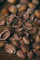 Whole nuts, shelled nuts and shells. Corylus avellana. Macro photo, close up, on wooden table.