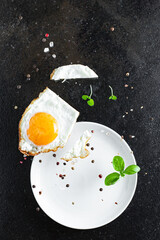 Fototapeta na wymiar fried egg yolk and white, fork for eat omelette dish and ingredients on the table serving size top view copy space for text food background rustic