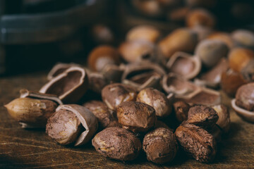 Whole nuts, shelled nuts and shells. Corylus avellana. Macro photo, close up, on wooden table.