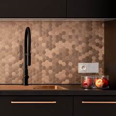 Golden hexagonal wall tiles in kitchen