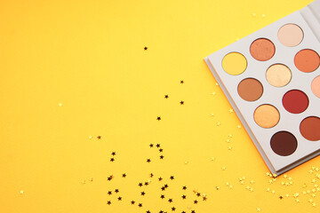 Eyeshadows on a yellow background professional cosmetics makeup brushes soft sponge fashion glasses