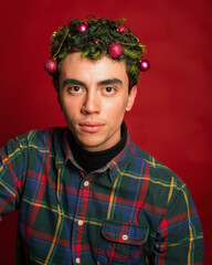 man in a plaid shirt on a red background in new year costume christmas mood green hair funny