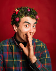 man in a plaid shirt on a red background in new year costume christmas mood green hair funny
