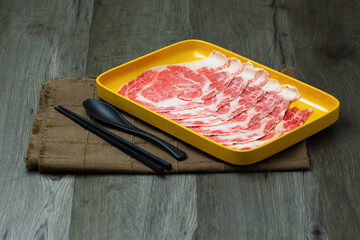 fresh raw pork, meat ,beef, belly, sliced on square plate  on wood, wooden background,set shabu, hot pot ingredients.