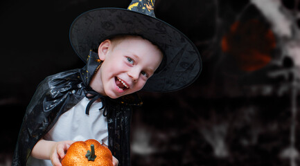 Portrait of a boy in a Halloween costume on a dark background. Happy Halloween. Carnival. Banner....