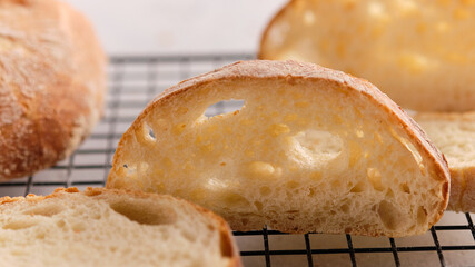Homemade ciabatta cools down on a wire rack.