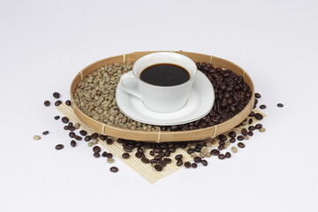 Black coffee is served in a glass cup, which is placed on a bamboo plate and sprinkled with neatly arranged coffee beans.