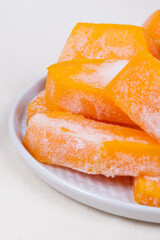 Frozen pieces of pumpkin on the plate.