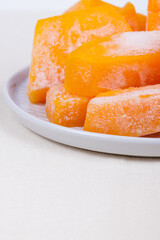 Frozen pieces of pumpkin on the plate.