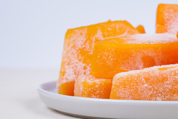 Frozen pieces of pumpkin on the plate.