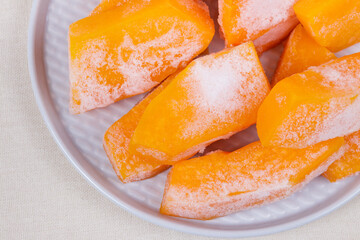 Frozen pieces of pumpkin on the plate.