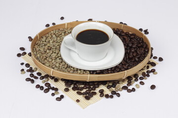 Serving black coffee on a white background, sprinkled with coffee beans.