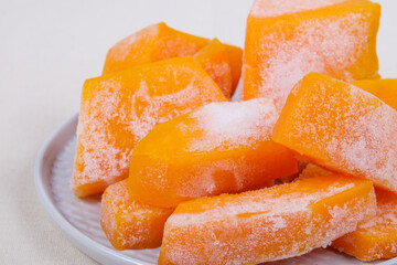 Frozen pieces of pumpkin on the plate.