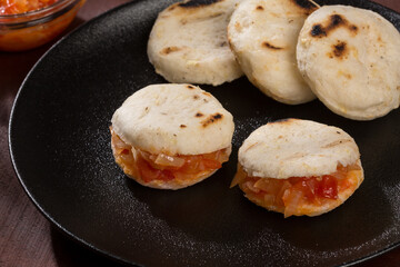 White corn arepa with hogao - tasty Colombian breakfast.