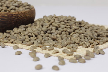 The pile of fresh coffee beans is green, showing the quality coffee beans and ready to be roasted.