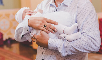 The sacrament of the baptism of a child. Selective focus.