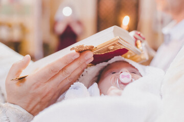 The sacrament of the baptism of a child. Selective focus.