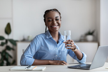 Hydration At Work. Happy Black Female Office Worker Holding Glass Of Water