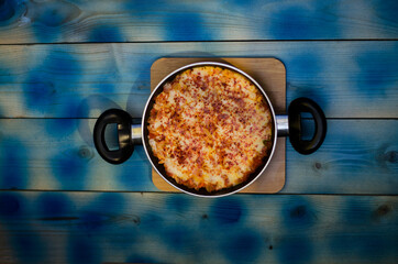 pan and dish, eat egg on blue wooden table
