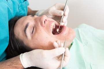 Close up frame of a dentist making a basic check up to a patient.