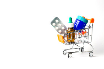 Cold and flu remedies in grocery cart. Tables, nasal drops, rubbing ointment.