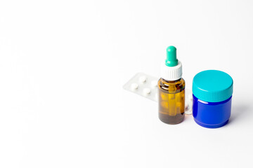 Remedies for colds and flu on a white background. Tablets, nasal drops, rubbing ointment.