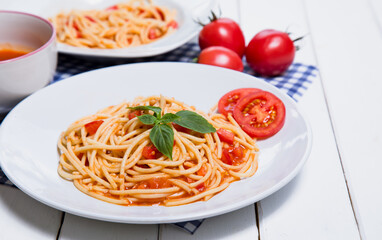 Spaghetti pasta with and tomato sauce on wood background