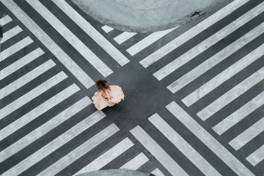 High Angle View Of Woman Dancing On Zebra Crossing On Street