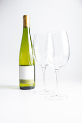 Glasses and bottle of wine on white background