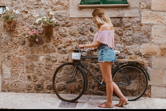 blonde woman choosing the bike like transport in Majorca