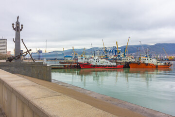 Russia, Novorossiysk - 03/26/2017: Seaport with boats on the Black Sea on a cloudy day.