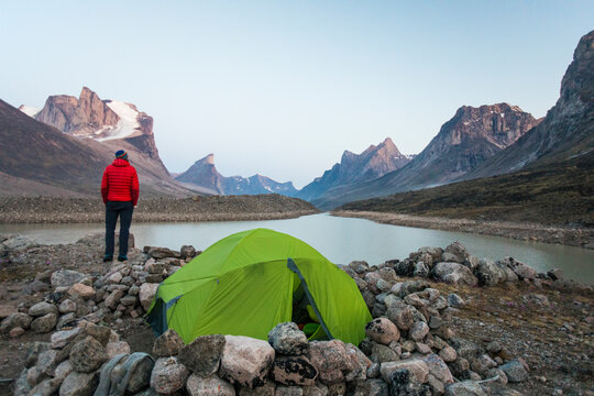 Climber enjoys view of Summit Lake from his campsite in Akshayak Pass