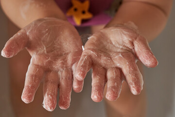 kid hands in soapy foam. The concept of hand washing, hygiene. Pandemic protection. Prevention