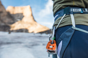 Detail view of climber harness with pulleys clipped on.