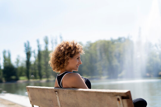 relaxed woman on the bench by the lake