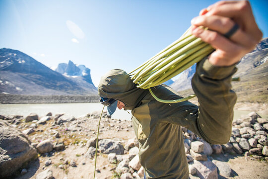 Climber prepares rope for another day of climbing on Baffin Island.