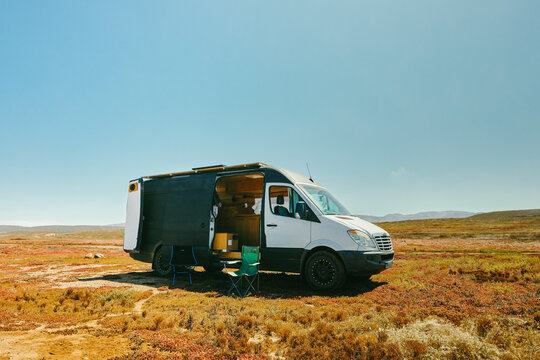 Camper van parked on ocean cliff beach during summer in Baja, Mexico.