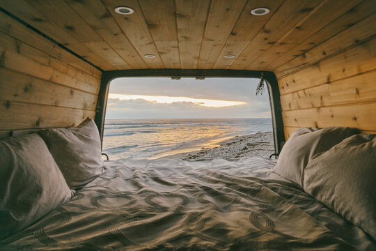 Views of sunset from open doors of sprinter van in Baja, Mexico.
