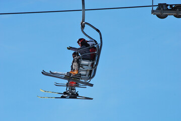 skiers on a lift