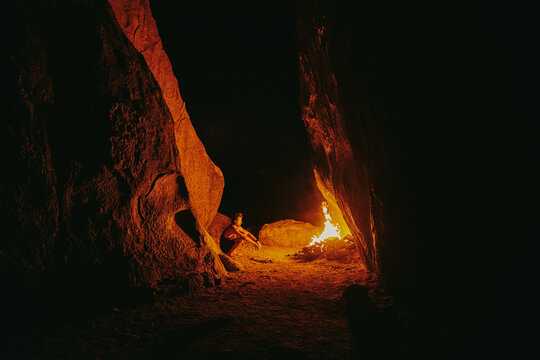 Young Couple In Front Of Camp Fire At Night In Northern California.