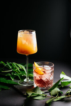 glass of alcoholic coctail with ice on black background