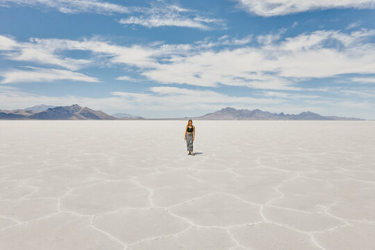 Young woman exploring Bonneville Salt Flats during a summer road trip.