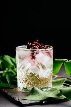 glass of alcoholic coctail with ice on black background