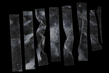 set of transparent adhesive tape or strips isolated on black background, crumpled plastic sticky...