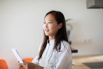 young asia female doctor with report in a practice