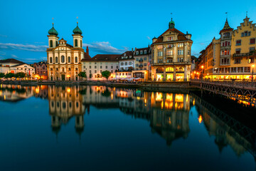 Lucerne cityscape by twilight and Lake Lucerne, Vierwaldstatersee, Canton of Lucerne in Central Switzerland. Jesuitenkirche or Jesuit Church reflects on Reuss river. Famous landmark of historical city