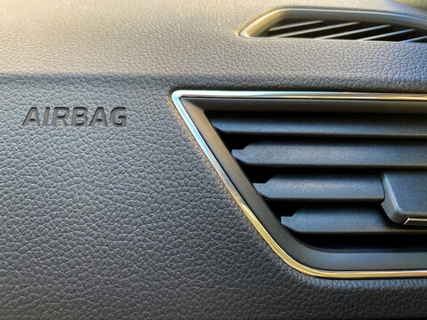 Macro of an airbag sign on a dashboard.
