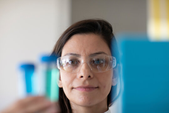 scientist female with lab glasses and sample in a lab