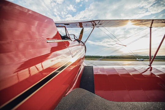 Red vintage antique Waco biplane at airport in Maine at sunrise