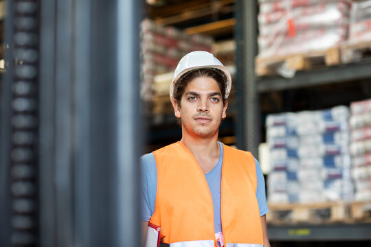 young store worker with helmet working in a store